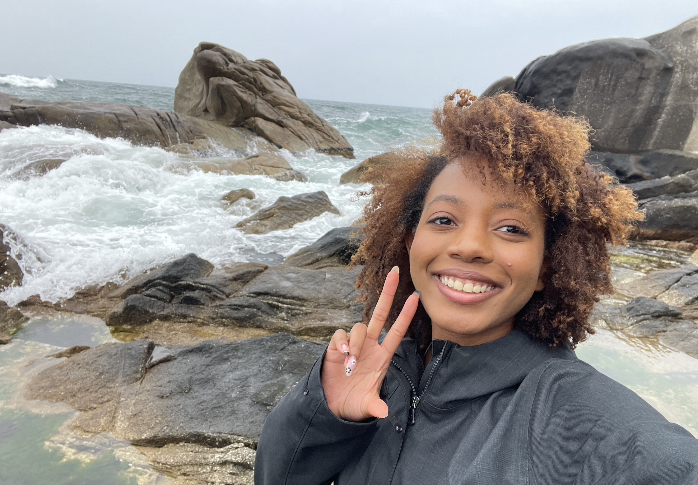 Alyssa Taylor takes a selfie behind the ocean.