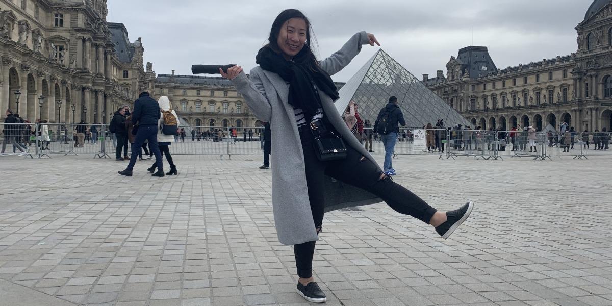 Angie Lee '21 poses in front of the Louvre in Paris, France.