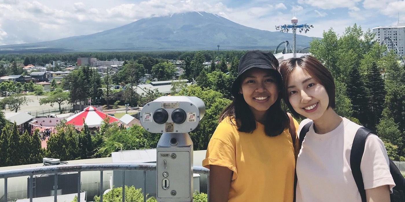 Jazlyn and a friend posing with Mount Fuji in the distance